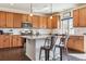 Bright kitchen with granite countertops, center island, stainless steel appliances and wood cabinetry at 5352 Truckee St, Denver, CO 80249