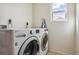 Bright laundry room featuring LG washer and dryer, plus a convenient ironing board for easy clothing care at 5352 Truckee St, Denver, CO 80249