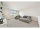 A cozy living room with gray upholstered furniture, carpeting, and a large window at 5352 Truckee St, Denver, CO 80249