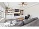 Bright living room featuring custom built-ins, a cozy fireplace, and a modern ceiling fan at 5352 Truckee St, Denver, CO 80249