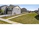 Spacious side yard featuring a well manicured lawn, sidewalk, and a white picket fence at 5352 Truckee St, Denver, CO 80249
