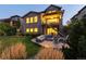 Inviting backyard with a stone patio, comfortable seating around a fire pit, and lush green grass at 10877 Skydance Dr, Highlands Ranch, CO 80126