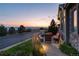 A peaceful view of a landscaped patio overlooking a scenic sunset and distant mountains, perfect for relaxing outdoors at 10877 Skydance Dr, Highlands Ranch, CO 80126
