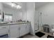 Bathroom featuring double vanity, large mirror, and walk-in shower for modern convenience at 9185 Wilde Ln # 101, Parker, CO 80134