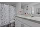 Modern bathroom featuring a vanity, toilet, and bathtub with an elegant marble shower curtain at 9185 Wilde Ln # 101, Parker, CO 80134