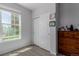 Bedroom boasts a large window and closet space, illuminated by natural light and featuring light grey walls at 9185 Wilde Ln # 101, Parker, CO 80134
