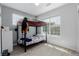 Bright bedroom featuring a bunk bed, light grey walls, and large windows letting in natural light at 9185 Wilde Ln # 101, Parker, CO 80134