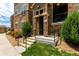 Condo front entrance featuring well-lit steps, stone accents, and a small front porch at 9185 Wilde Ln # 101, Parker, CO 80134