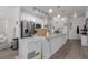 Bright open kitchen with stainless steel appliances, a large center island, and hard surface countertops at 9185 Wilde Ln # 101, Parker, CO 80134