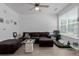 Comfortable living room with large sectional sofa, modern ceiling fan, and plenty of natural light at 9185 Wilde Ln # 101, Parker, CO 80134