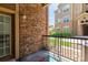 Cozy outdoor patio featuring brick accents and black metal railing, perfect for relaxing outdoors at 9185 Wilde Ln # 101, Parker, CO 80134