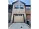 Attached garage providing convenient parking with neutral paint, set in a rock bed landscape at 3584 Central Park Blvd, Denver, CO 80238