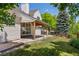 Backyard featuring a covered patio, well-maintained lawn, and mature trees for added privacy at 5944 E Irwin Pl, Centennial, CO 80112