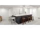 Basement bar area with a bar, modern stools, and a sink for entertaining at 5944 E Irwin Pl, Centennial, CO 80112