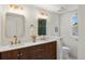 Modern bathroom boasting double vanity with gold fixtures and stylish tiled shower at 5944 E Irwin Pl, Centennial, CO 80112