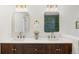 Elegant bathroom with double sinks, dark wood cabinets, and gold framed mirrors at 5944 E Irwin Pl, Centennial, CO 80112