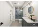 Bathroom with a marble countertop vanity, modern fixtures, and an enclosed shower at 5944 E Irwin Pl, Centennial, CO 80112