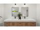 Bathroom featuring double sinks and modern fixtures with plenty of counter space at 5944 E Irwin Pl, Centennial, CO 80112