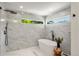 Contemporary bathroom featuring a freestanding tub, walk-in shower, and stylish tile work at 5944 E Irwin Pl, Centennial, CO 80112