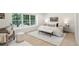 Bright bedroom with big window, neutral decor, comfy furniture, and light hardwood floors at 5944 E Irwin Pl, Centennial, CO 80112