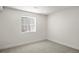 Empty bedroom with plush carpet and a window providing natural light at 5944 E Irwin Pl, Centennial, CO 80112