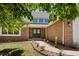 Charming front entrance with brick facade, well-manicured landscaping, and a welcoming double door at 5944 E Irwin Pl, Centennial, CO 80112