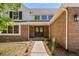 Charming front entrance with brick facade, well-manicured landscaping, and a welcoming double door at 5944 E Irwin Pl, Centennial, CO 80112
