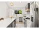 Modern kitchen with stainless steel appliances, island, farmhouse sink and pendant lighting at 5944 E Irwin Pl, Centennial, CO 80112