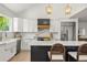 Bright kitchen boasts white cabinets, stainless steel appliances, kitchen island, and pendant lighting at 5944 E Irwin Pl, Centennial, CO 80112