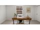 Bright office space features a classic desk and natural lighting from a large window at 5944 E Irwin Pl, Centennial, CO 80112