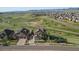 Aerial view of a home surrounded by lush greenery, complemented by mountain views at 17102 W 85Th Pl, Arvada, CO 80007