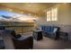 Covered back porch with a view of rolling hills, featuring comfortable seating and string lights at 17102 W 85Th Pl, Arvada, CO 80007
