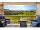 A scenic view of rolling hills from a cozy deck setting, featuring comfortable seating and a warm ambiance at 17102 W 85Th Pl, Arvada, CO 80007