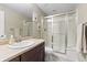 Bathroom featuring a vanity with sink and a glass-enclosed shower, offering a clean and functional design at 17102 W 85Th Pl, Arvada, CO 80007