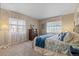 Bright bedroom featuring a comfortable bed, soft natural light, and beautiful neutral decor at 17102 W 85Th Pl, Arvada, CO 80007