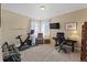 Carpeted bonus room featuring neutral paint, a Peloton, weight equipment and office area at 17102 W 85Th Pl, Arvada, CO 80007