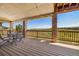 Relaxing covered deck offers a serene view of lush greenery and rolling hills in the distance at 17102 W 85Th Pl, Arvada, CO 80007