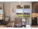 Dining room with a view of the neighborhood; a chair sits in the corner next to the dining table at 17102 W 85Th Pl, Arvada, CO 80007