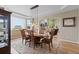 Elegant dining room with hardwood floors, large window, and modern chandelier at 17102 W 85Th Pl, Arvada, CO 80007