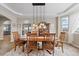 Spacious dining room featuring hardwood floors, modern lighting, and a view to the backyard at 17102 W 85Th Pl, Arvada, CO 80007