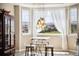 Dining room features a chandelier, a window with sheer curtains, and a small table with chairs at 17102 W 85Th Pl, Arvada, CO 80007