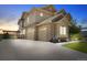 Stately home featuring a three-car garage, stone accents, and a pergola at 17102 W 85Th Pl, Arvada, CO 80007