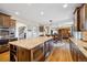 Open-concept kitchen flowing into the living area, featuring a large island and modern appliances at 17102 W 85Th Pl, Arvada, CO 80007
