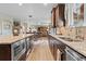 Modern kitchen with stainless steel appliances, granite countertops, and open layout at 17102 W 85Th Pl, Arvada, CO 80007