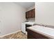 Functional laundry room features modern appliances and a utility sink at 17102 W 85Th Pl, Arvada, CO 80007