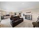 Expansive carpeted living room featuring an office, home gym area, and comfortable seating at 17102 W 85Th Pl, Arvada, CO 80007