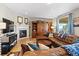 Cozy living room with fireplace, leather sectional, and sliding barn door at 17102 W 85Th Pl, Arvada, CO 80007