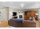 Comfortable living room with a fireplace, large leather sofa, and ample natural light at 17102 W 85Th Pl, Arvada, CO 80007