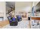 Inviting living room featuring leather recliners, open floor plan, and beautiful staircase at 17102 W 85Th Pl, Arvada, CO 80007