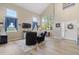 Bright living room with vaulted ceilings, large windows, and stylish decor at 17102 W 85Th Pl, Arvada, CO 80007